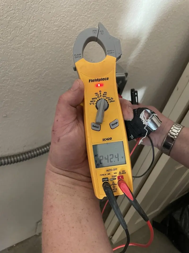 Voltage testing with clamp meter during Whole House Surge Protector in South Hadley